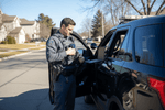 Law enforcement officer preparing tactical first aid kits for law enforcement during patrol.