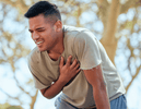 Man experiencing chest pain during exercise, illustrating when not to use first aid and seek professional help.