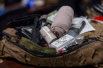gun carry trauma kit with various medical supplies and equipment in a tactical bag for emergency situations