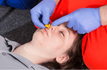 Demonstrating nasopharyngeal airway management technique during emergency response training session.