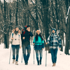 First Aid Essentials for Snow Trekking and Winter Hiking - group of hikers walking in snow-covered forest.