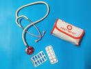 On-Hand vehicle trauma kit with CAT tourniquet, stethoscope, first aid kit, and medication packages on a blue background.