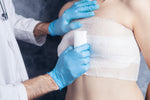 IFAK hemostatic agents for trail emergencies: medical personnel applying a pressure dressing.