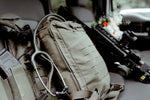 Essential trauma kits for outdoorsmen gear, including a tactical backpack, stethoscope, and firearm.