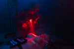 A soldier uses a general purpose first aid backpack for vehicle trauma in a simulated emergency scenario.