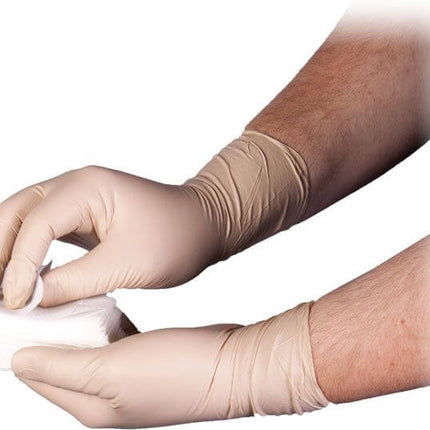 Person wearing latex gloves holding ChitoGauze® XR PRO hemostatic Z-fold gauze for wound care.