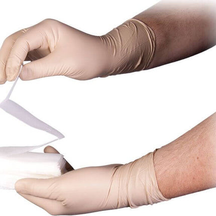 Person in gloves holding a Z-Fold gauze, demonstrating use of hemostatic gauze for wound care.