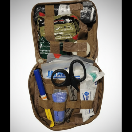Open Enhanced Individual First Aid Kit showing medical supplies, scissors, and trauma essentials.