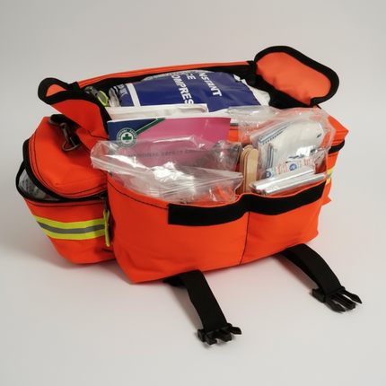 Orange emergency medical bag with supplies on a black background