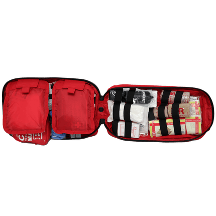 Open tactical trauma kit featuring organized first aid supplies and rip-away pockets for quick access.