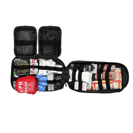 Open tactical trauma kit displaying essential medical supplies and tools for emergency response.