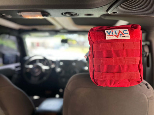 ViTAC adventurer first aid kit securely attached in vehicle, perfect for emergencies on outdoor adventures.