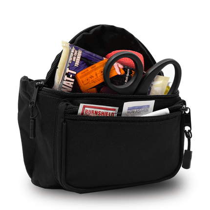 First aid fanny pack filled with emergency supplies like bandages, gauze, scissors, and burn treatments.