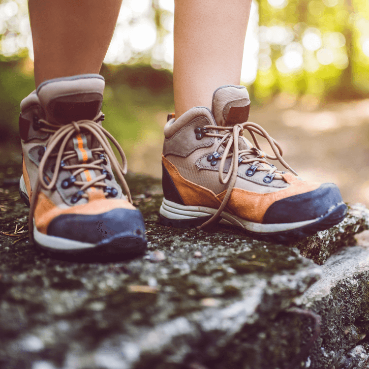 Essential Tips for Hiking Boot Selection and Blister Prevention with rugged hiking boots on a rocky surface.