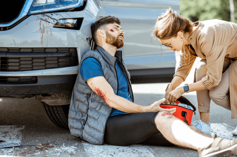 The Critical Role of Emergency Trauma Dressings in first aid for a man injured in an accident, receiving help.