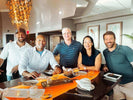 A group of five friends enjoying a meal together, representing a Veteran-Owned First Aid Company.