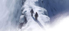 ViTAC's Guide to Proper Layering for Cold Weather: two hikers navigating a snowy cliff.