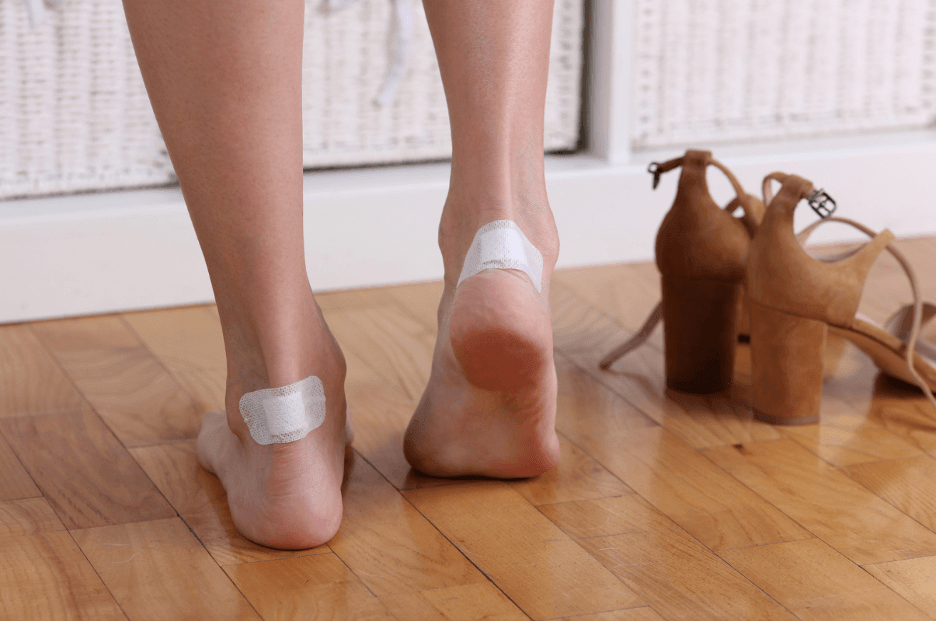 Blister Treatment on the Trail: Prevention and Care Guide for Hikers - woman applying bandages on blistered heels.