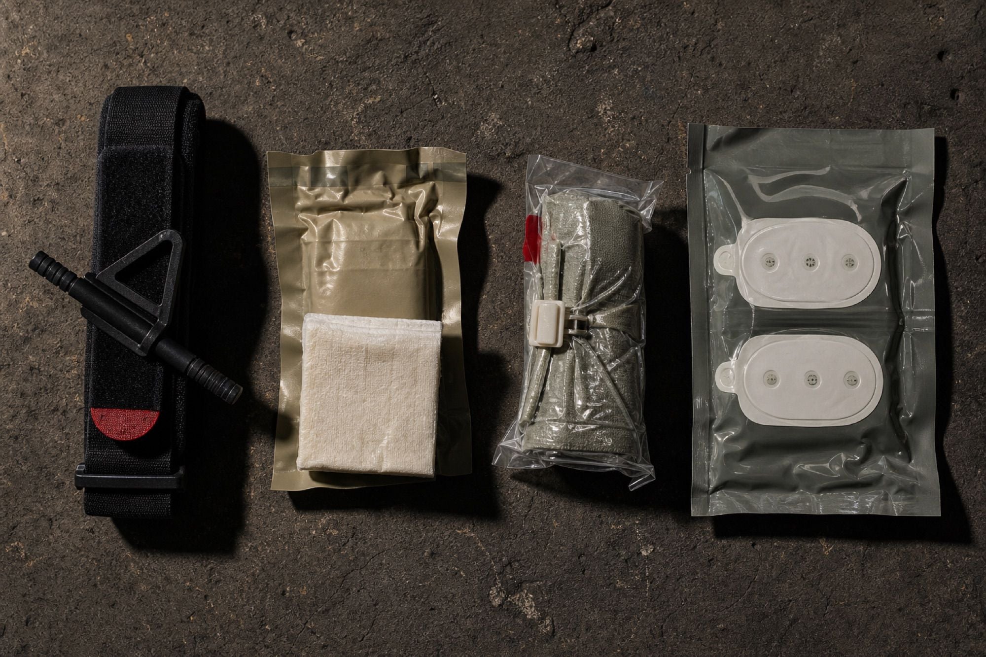 Premium IFAK trauma kit with components laid out on tactical surface