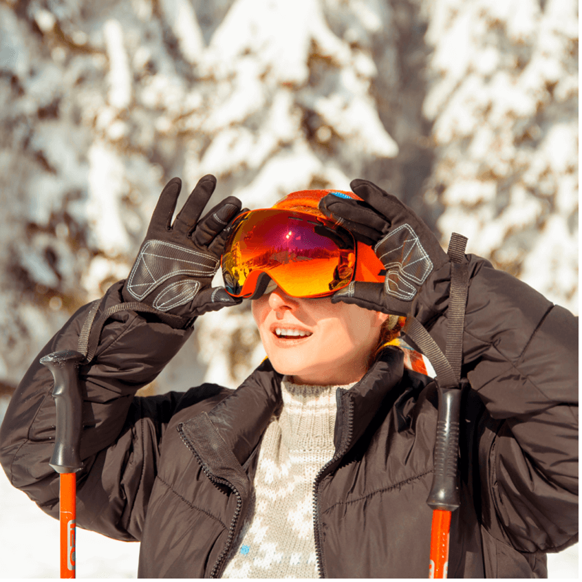 Woman wearing ski goggles outdoors, focusing on Essential Tips for Snow-Blindness Prevention and Treatment.