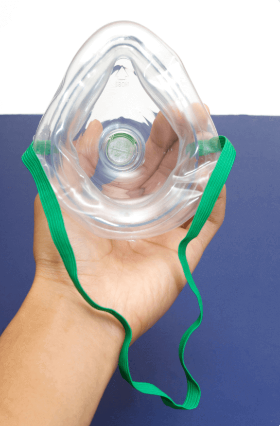 Life-Saving Techniques - How to Use a CPR Mask Properly - close-up of a CPR mask held in hand with green straps.