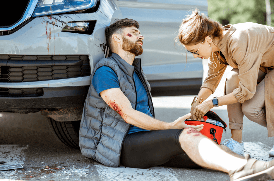 The Critical Role of Emergency Trauma Dressings in first aid for a man injured in an accident, receiving help.