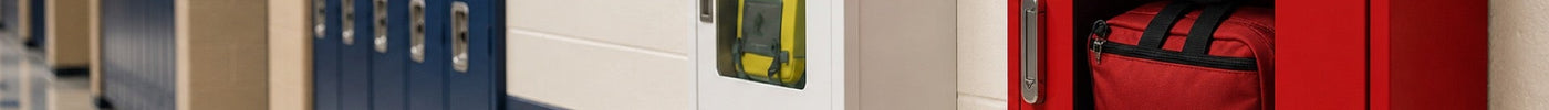 School hallway wall-mounted bleed control kit station positioned near classroom door for immediate student and staff access