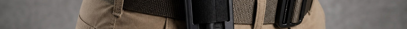 Tourniquet staged in a belt-loop carry position — ready for immediate access in a vehicle, pack, or IFAK