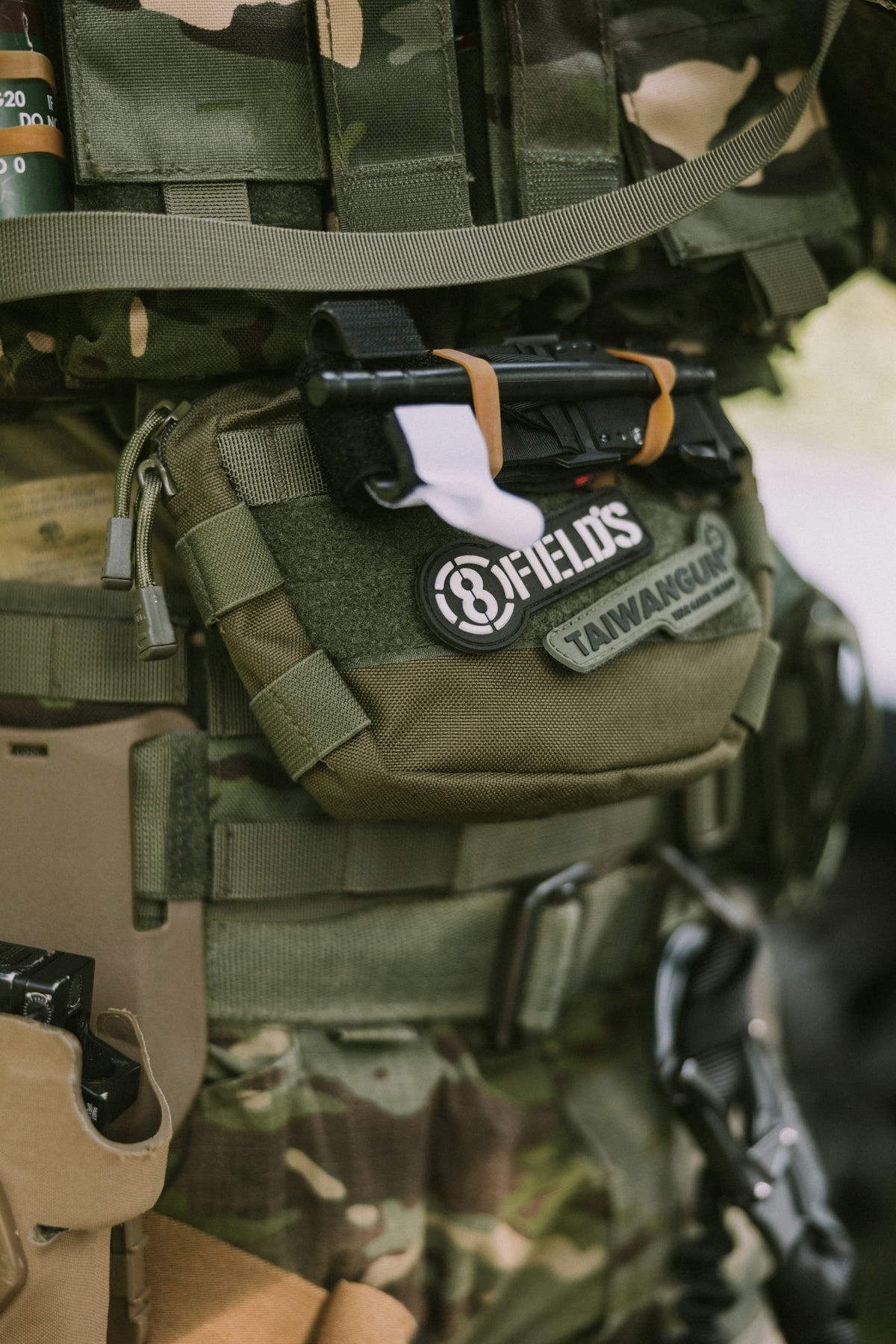 Close-up of a compact trauma kit for everyday carry attached to tactical gear.