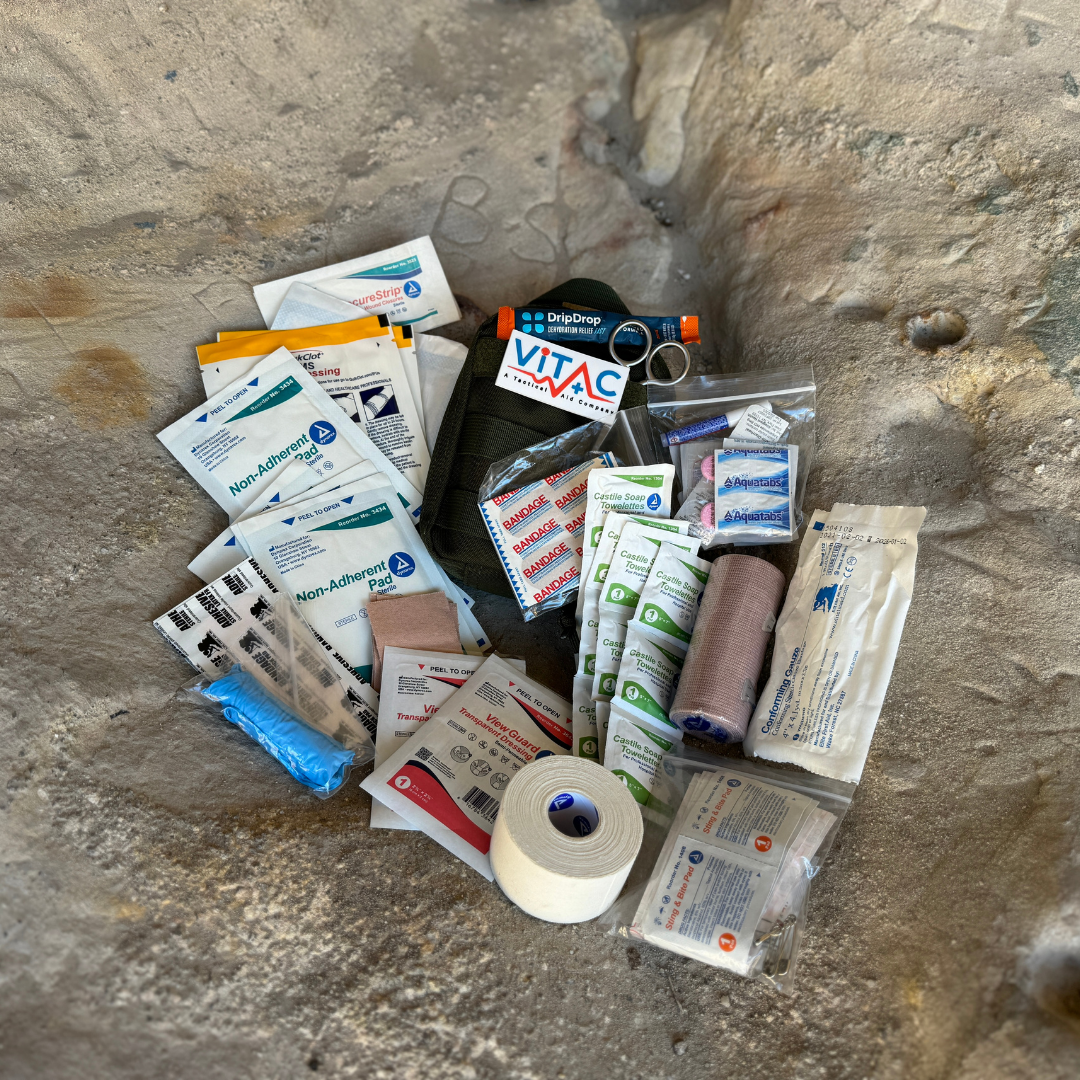 hsa fsa eligible first aid kit and supplies on a rock face