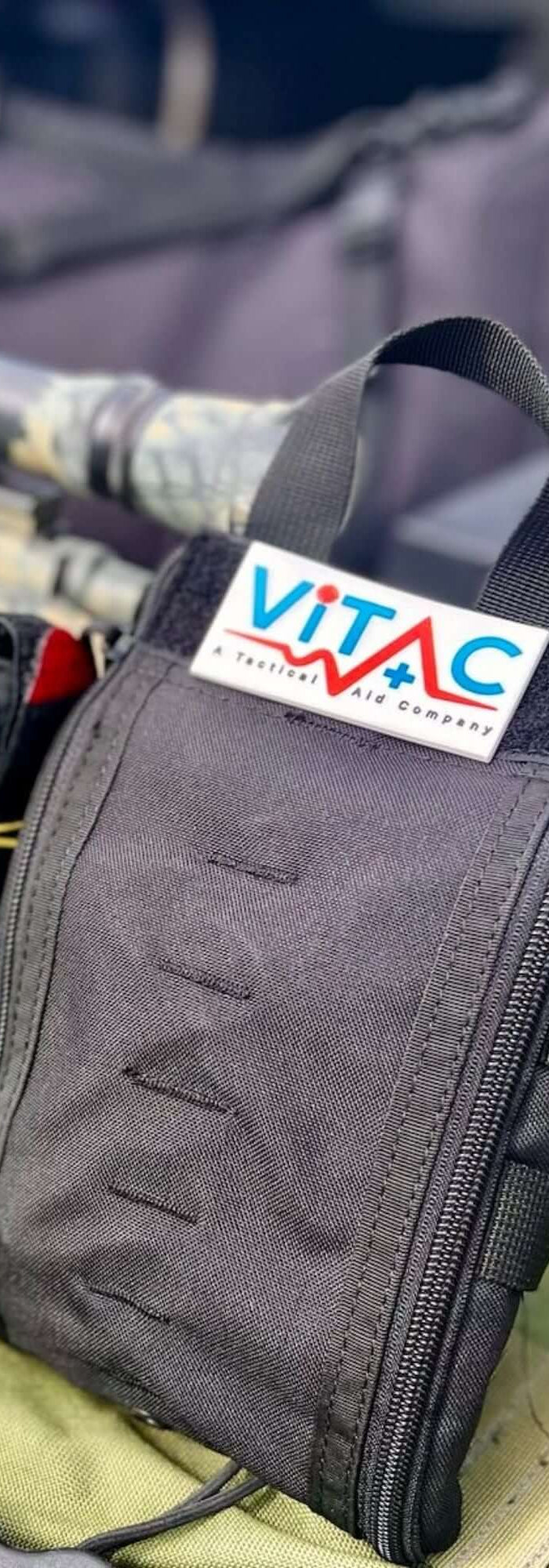 Individual First Aid Kit attached to a tactical rifle showcasing compact storage for quick access in emergencies.