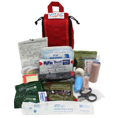 Trauma kits with nasopharyngeal airway displayed with various medical supplies and a red bag.