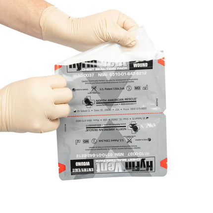 HyFin Vented Chest Seal Twin Pack being unwrapped, ideal for treating open and tension pneumothorax injuries.