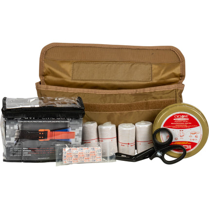 First aid kit with bandages, scissors, and other supplies on a white background