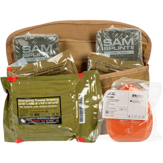 First aid kit with various medical supplies including SAM splints and trauma dressing on a white background.