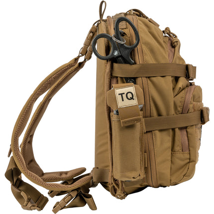 Brown tactical backpack with a patch labeled 'TQ' on a white background