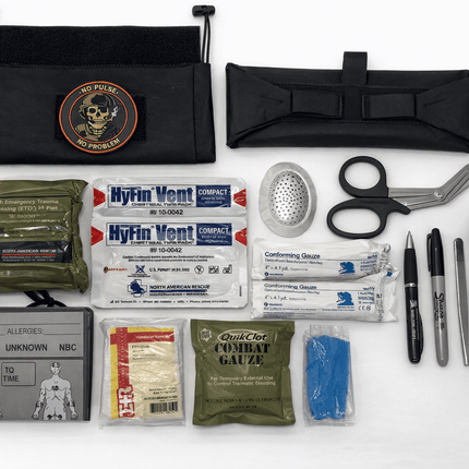 First aid kit and survival tools on a white background