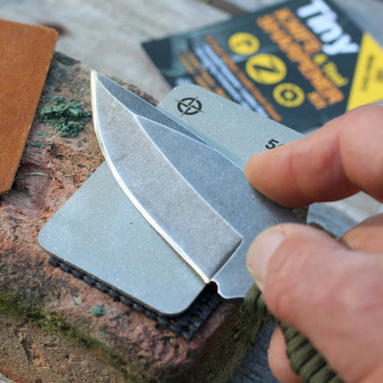 Tiny Knife Sharpener Kit - EDC being used to sharpen a knife blade outdoors.