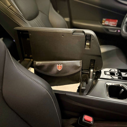 The Stay Safe Self Defense Kit stored in a compact pouch in a car console for easy access.