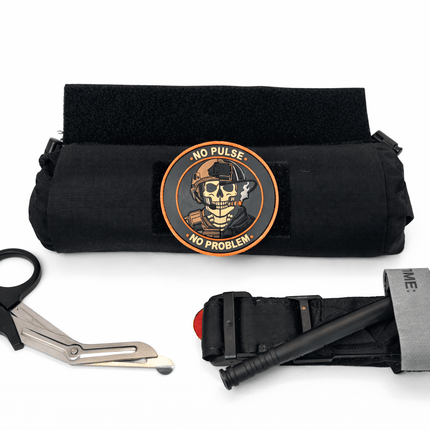 First aid kit with shear, CAT tourniquet, and 'No Pulse No Problem' patch on a white background