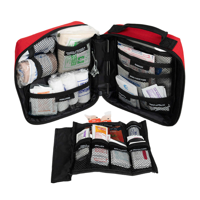 First aid kit with various supplies on a white background