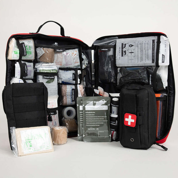 Open Ultimate Survival Med Kit showcasing trauma supplies and first aid essentials for 4 people.