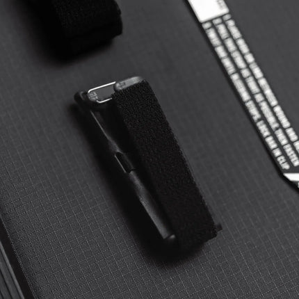 Close-up of the Snakestaff Systems tourniquet attachment features for secure carrying.