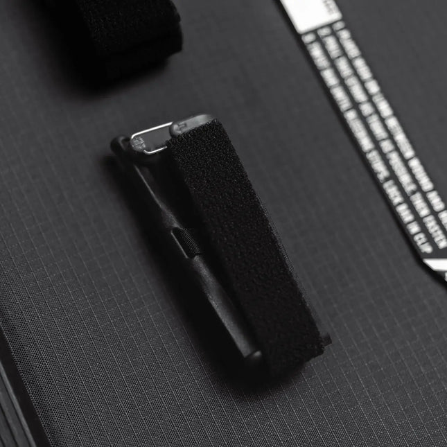 Close-up of the Snakestaff Systems tourniquet attachment features for secure carrying.