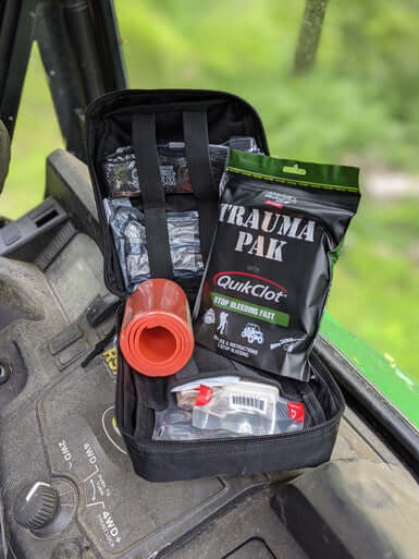 Open Premium IFAK Trauma Kit displaying QuikClot Trauma Pak and various emergency care supplies.
