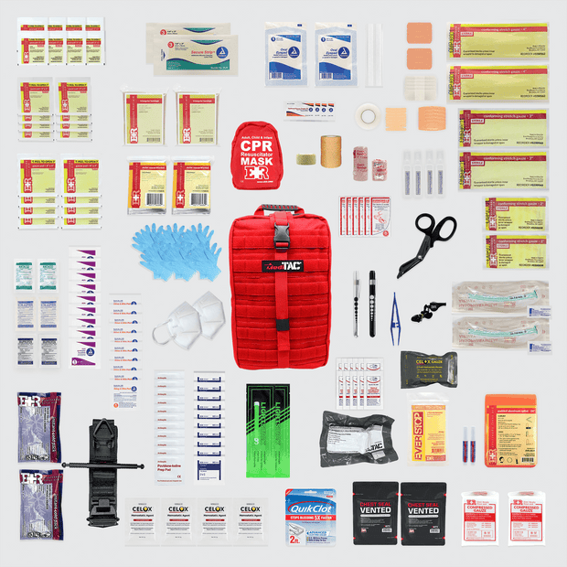 Red Rip-Away Tactical Trauma Kit with various first aid supplies arranged neatly on a surface.