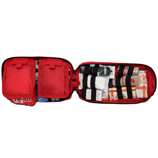 Open tactical trauma kit featuring organized first aid supplies and rip-away pockets for quick access.
