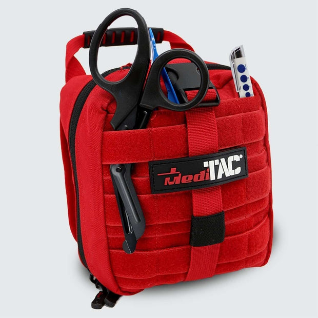 Small Rip Away Tactical Trauma Kit by MediTac in red with scissors and essential tools, designed for emergency response.