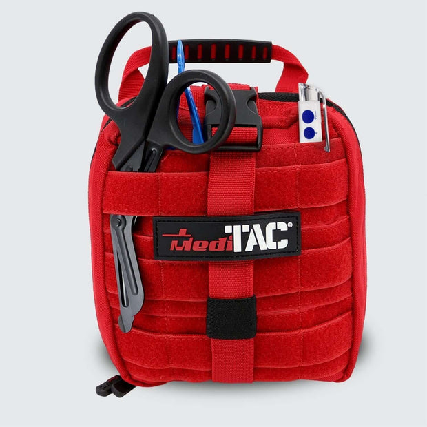 Small Rip Away Tactical Trauma Kit in red with scissors and EMT tools for emergency response.