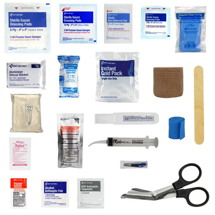 Collection of first aid supplies including bandages, gauze, and scissors on a white background.